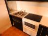 Kuhinjsko pohištvo z napo, kuhališčem, pečico in hladilnikom